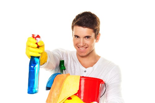 Professional carpet cleaner following safe working procedures